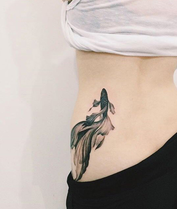 tatuagem de peixe koi na costela 