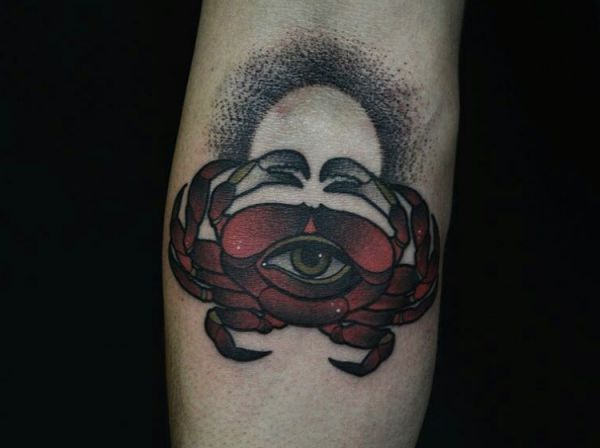 Caranguejo com olho vermelho no antebraço 