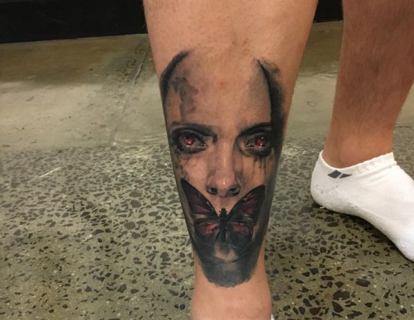 Tatuagem de borboleta gótica na perna 