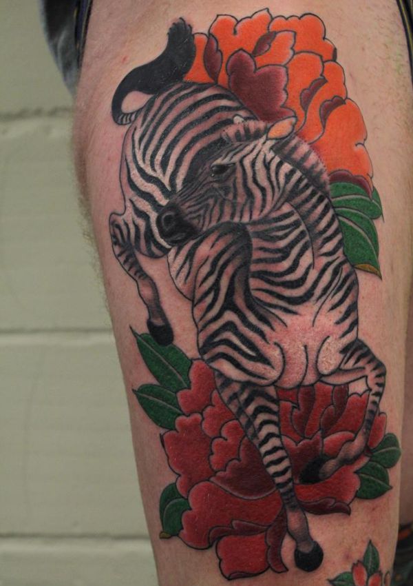 Tatuagem de zebra com flores na coxa 