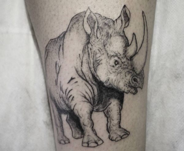Tatuagem de rinoceronte na parte inferior da perna em preto e branco 