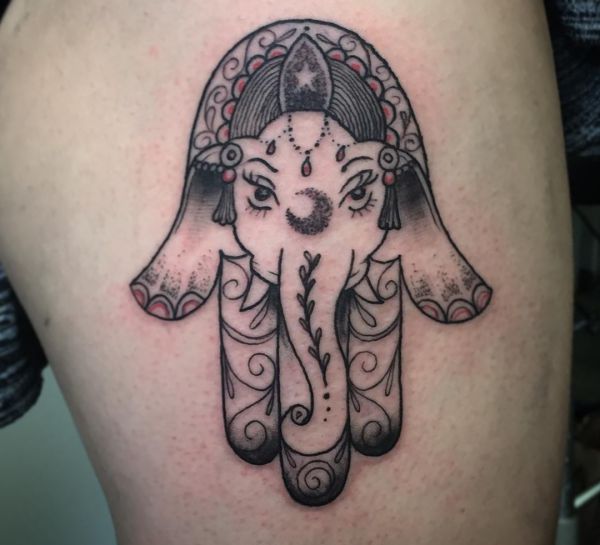 Mão de Hamsa e tatuagem de elefante na coxa 